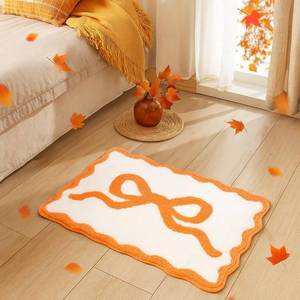 lot 8929 image: Coquette Scalloped Bow Bath Mat (Orange)