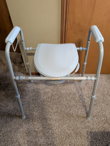 lot 205 image: Adjustable Bedside Commode Chair w Safety Handles