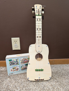 lot 234 image: Wooden Ukulele & Emergency Puzzle Set